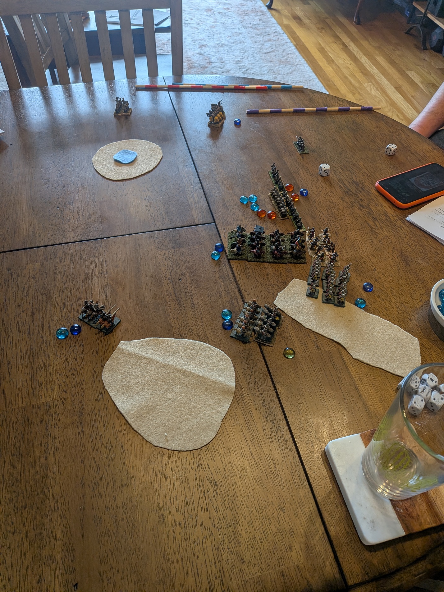 Miniature armies in melee in front of the well
