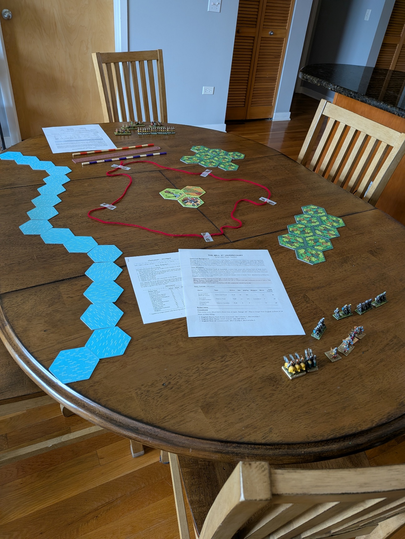 Tabletop setup for the Mill at Vaudricourt, with the hill outlined in red yarn and armies deployed on opposite sides